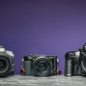 An image of three cameras with a purple background