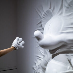 A visitor examines a sculpture at "Mickey: The True Original & Ever Curious" exhibition on July 26, 2022 in Beijing, China.