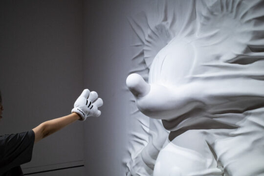 A visitor examines a sculpture at "Mickey: The True Original & Ever Curious" exhibition on July 26, 2022 in Beijing, China.
