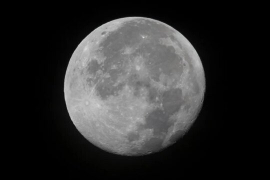 A full moon against an inky black space backdrop.