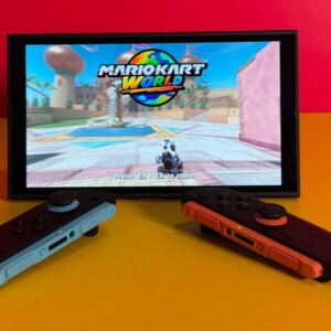 A Switch 2 on a table with controllers detached and Mario Kart World on the screen