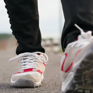 Two feet in walking shoes on pavement