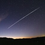 gorgeous purple night sky with long white streak