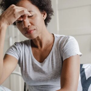 Woman holding the bridge of her nose while feeling stressed