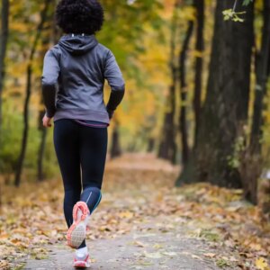 Woman jogging through the woods