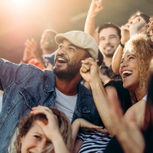 group of people taking a selfie in what appears to be a concert or crowded event
