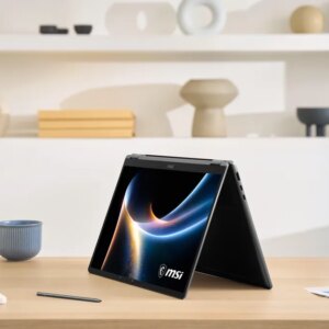 The Prestige 16 Flip AI sits flipped into tablet mode on a table.