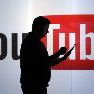 Man using phone in front of YouTube logo