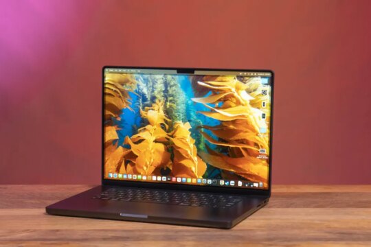 An Apple MacBook Pro 16 M4 sits open on a table.