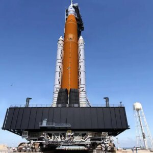 A photograph of NASA's SLS rocket system with the Orion capsule attached