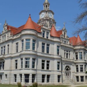 Three-story courthouse with corner gables.