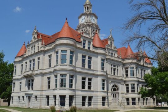 Three-story courthouse with corner gables.
