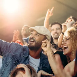 group of people taking a selfie in what appears to be a concert or crowded event