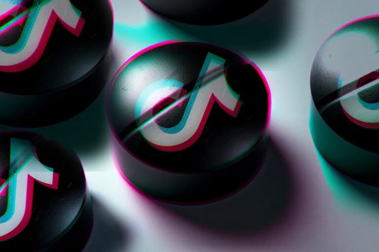 Tablet pills with the TikTok logo spread across a white surface