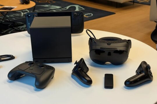 Valve's lineup of 2026 products in black: Steam Machine, Steam Controller, Steam Frame and Steam Deck in view on table